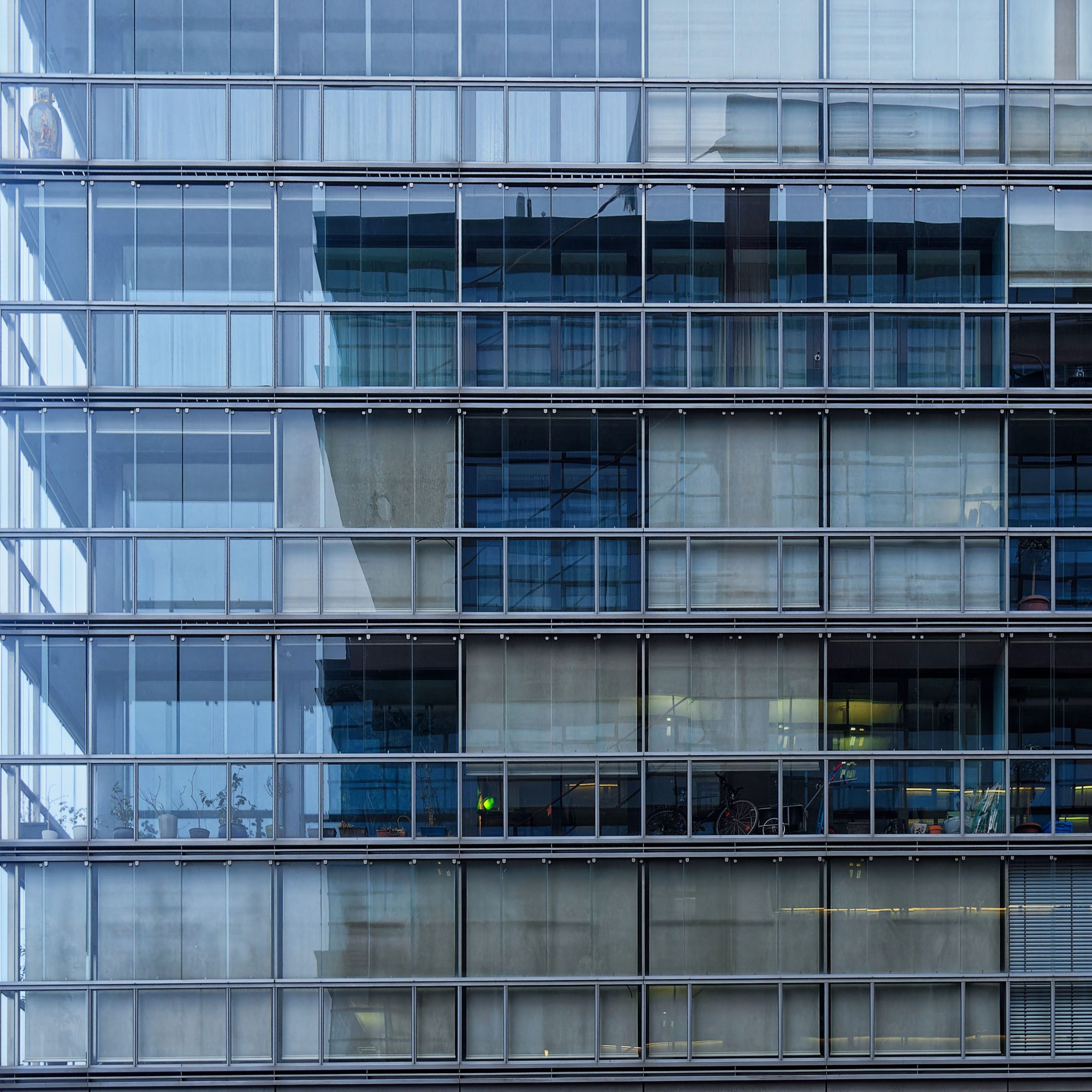 Close-up of a contemporary glass facade of a modern urban office building.