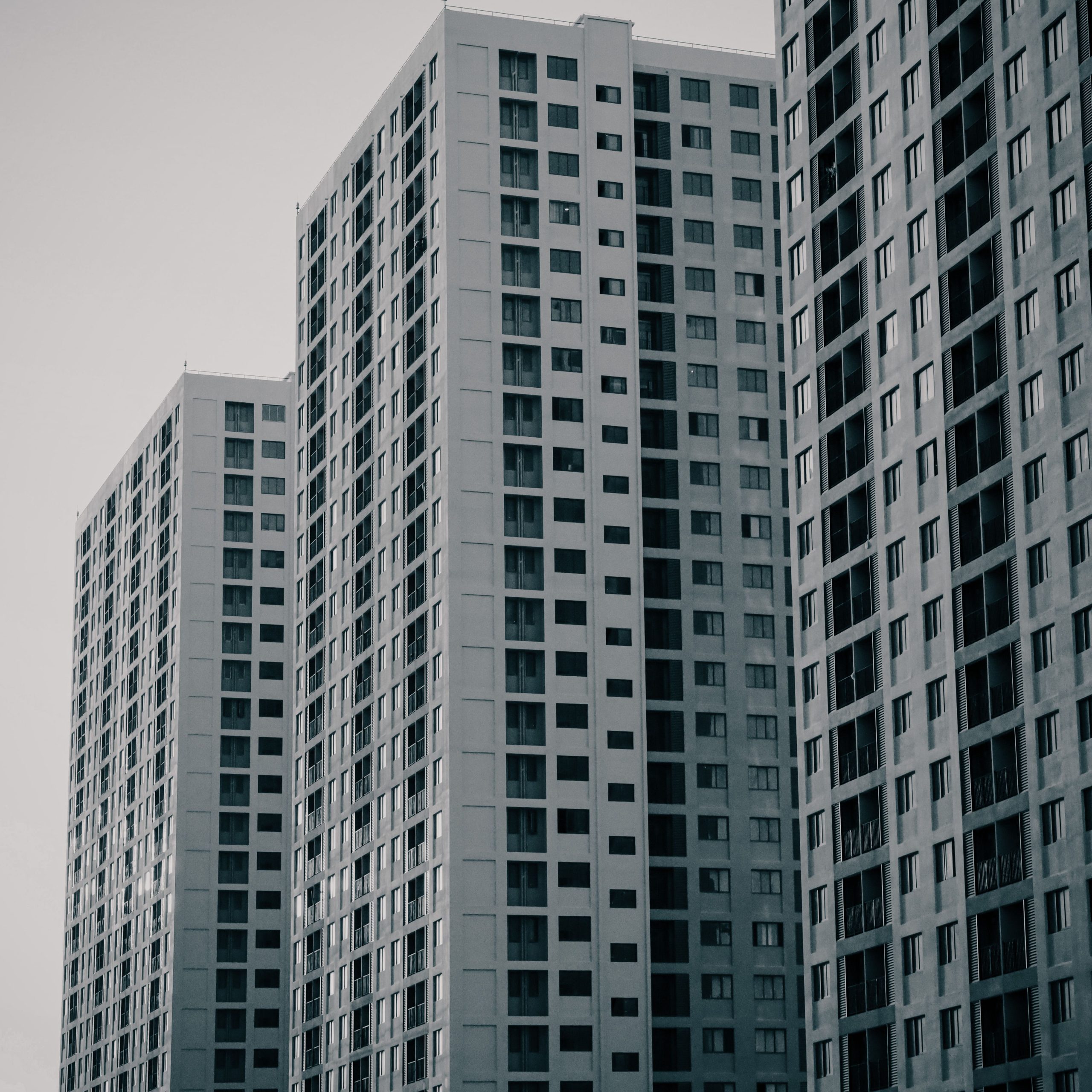 Monochrome image of modern skyscrapers showcasing urban architecture in daylight.